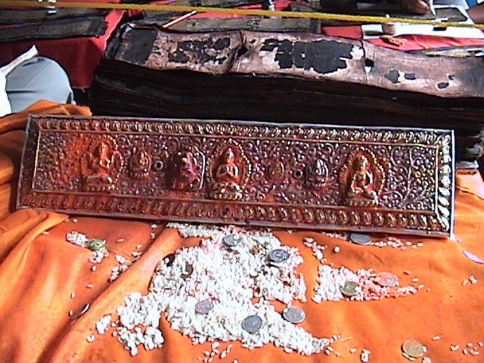 Sculpted cover of an AsP Ms in worship during restoration of the manuscript, Patan, Nepal.