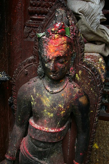 Statue of bodhisattva Avalokitevara (9th or 10th century) with signs of worship.