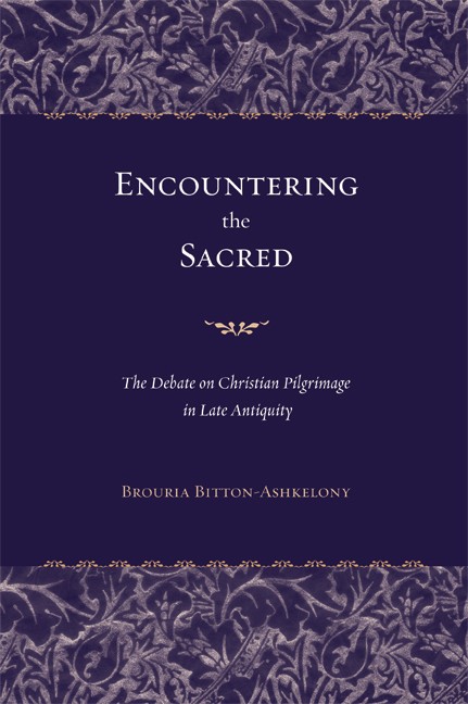 Book cover for Encountering the Sacred. Text is white or gold. Background is deep purple. Text is bordered by intricate floral bands in lighter violet and silver at the top and bottom separated by thin gold borders.
