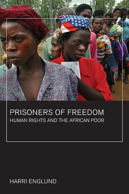 Book cover for Prisoners of Freedom. Above: A photo shows women lined beside a wire fence with two in head wraps in front. Text is white. Background is black with a thin white square frame overlaid in the center.